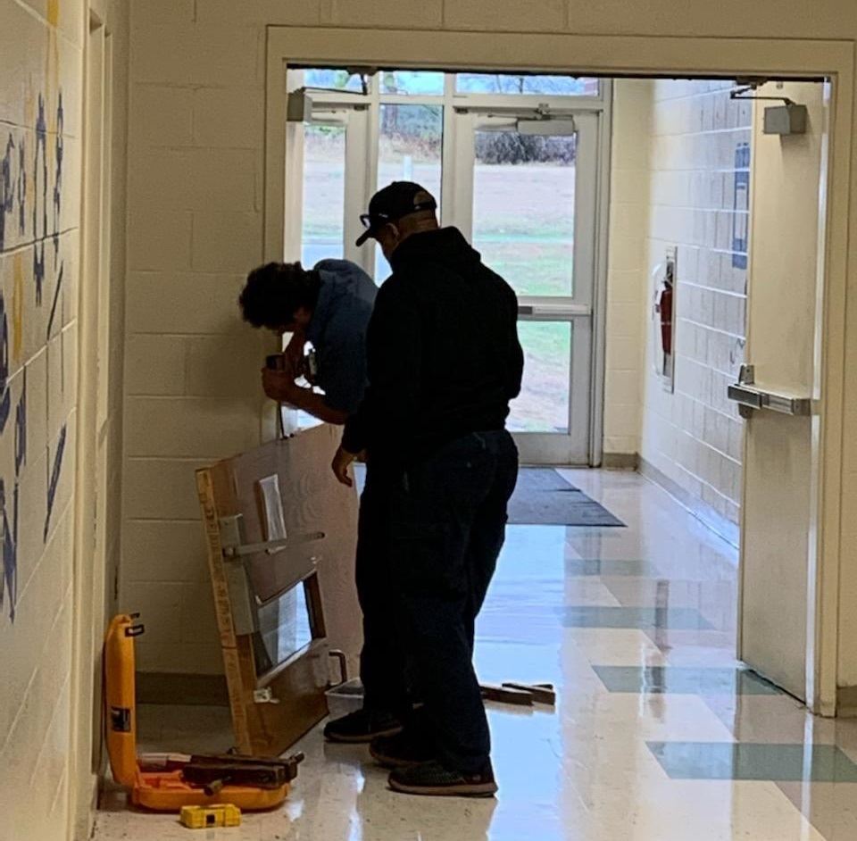 Maintenance employees working in a school Maintenance employees working in a school